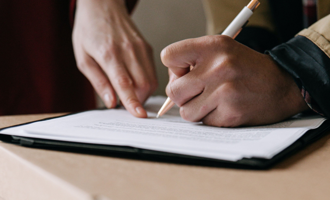 A guy writing in paper