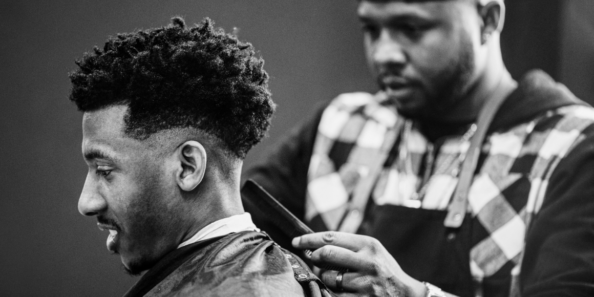 barber cutting a mans hair