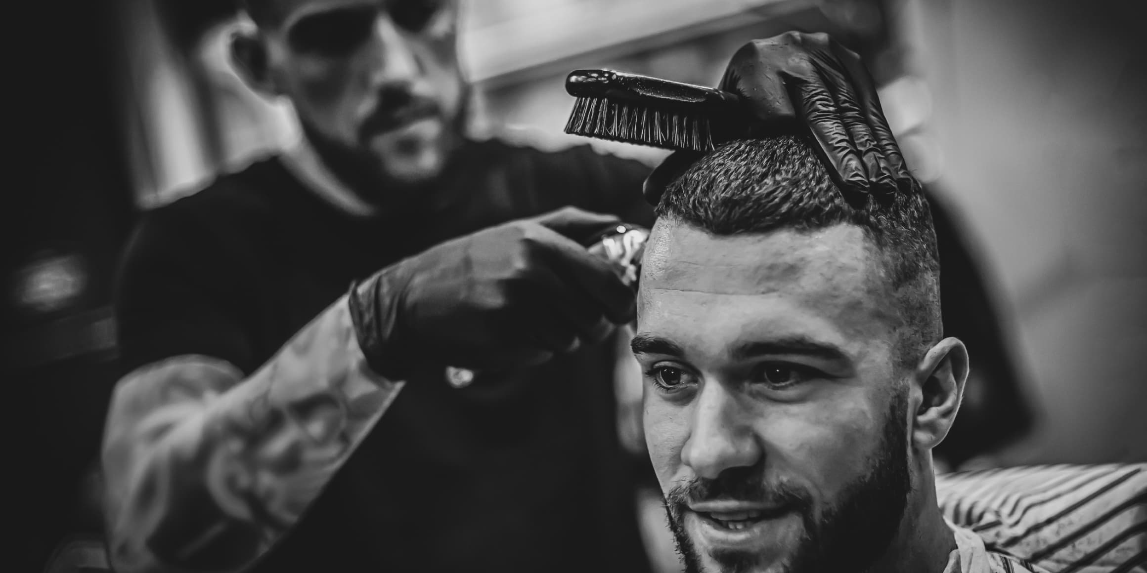 barber cutting client hair with trimmer