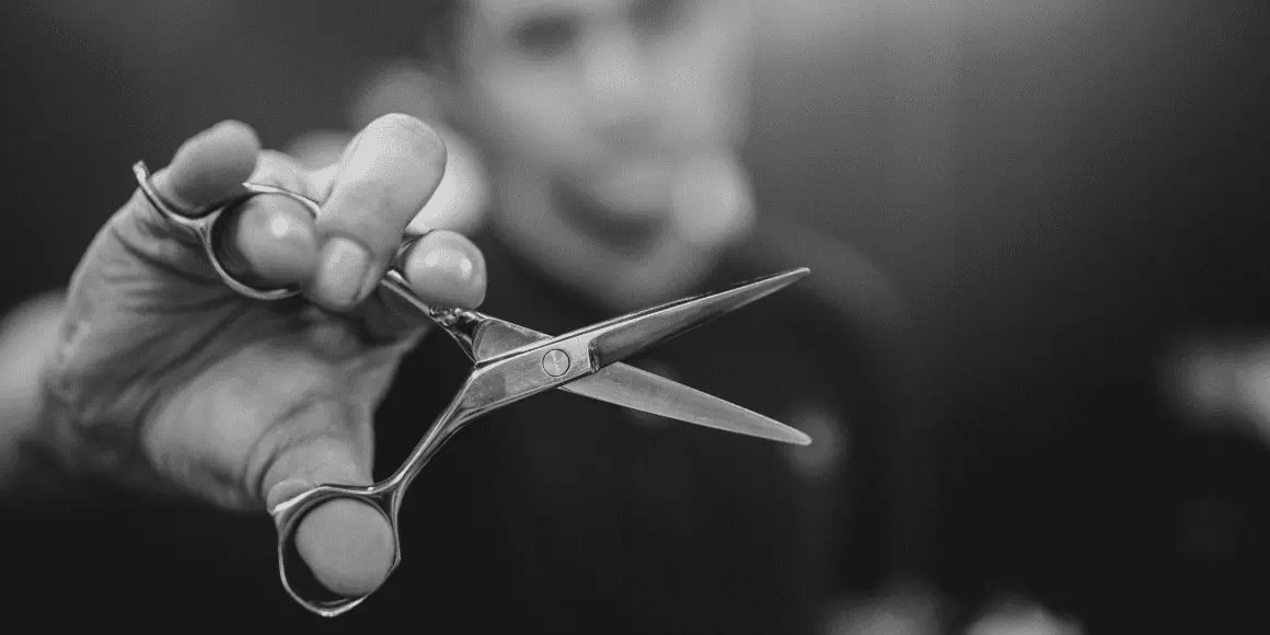 barber holding scissors
