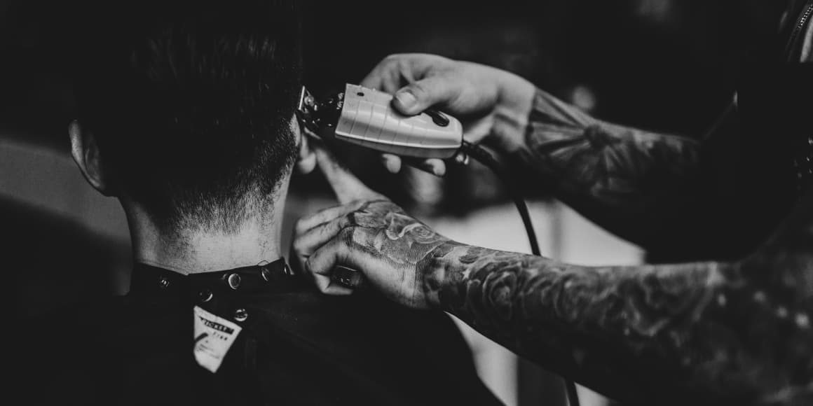 barber trimming customer hair