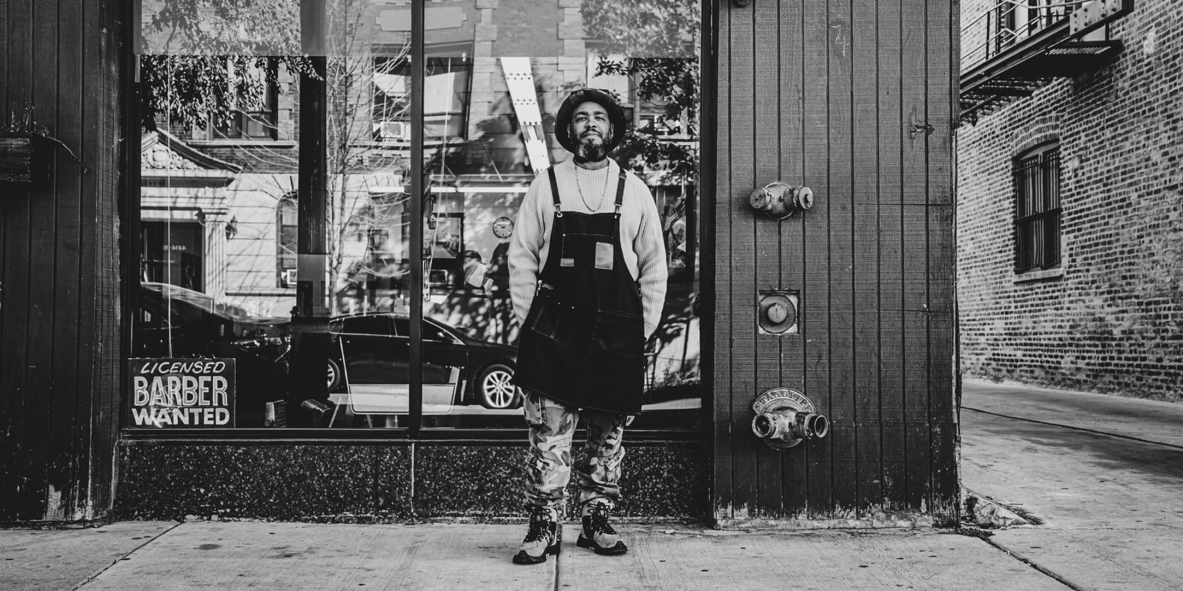 barber standing at his barbershop